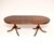 A lovely antique Regency style extending dining table. This was made in England, it dates from around the 1950’s. It has a...