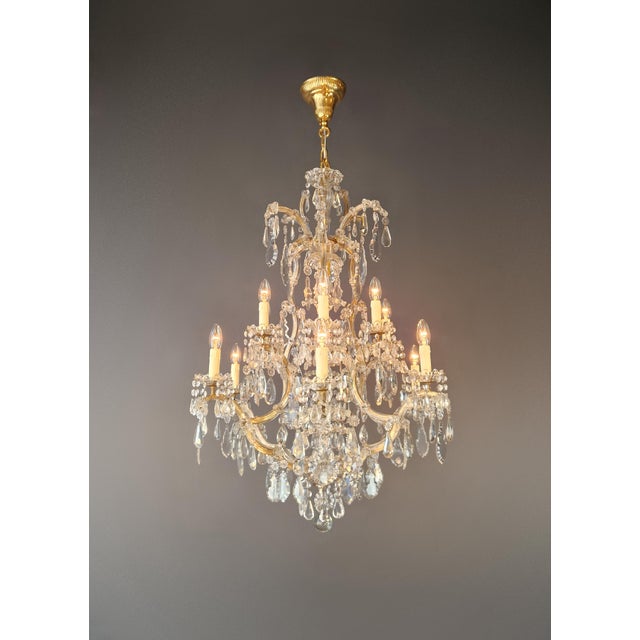 A classic chandelier in the Maria Theresa style, distinguished by its refined detailing and balanced elegance. This piece...