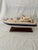 A nicely, detailed wooden model of a blue and white yacht. Great size super nice quality.