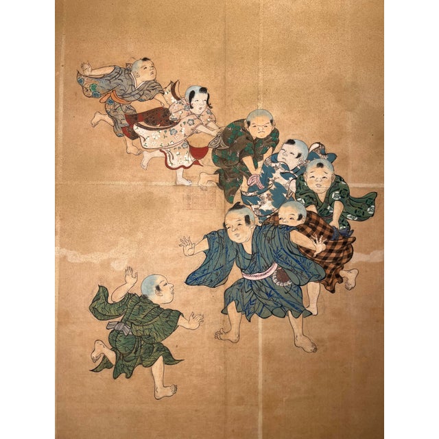 Offered for sale is a beautiful antique Japanese painting on paper depicting a lively group of children at play,...