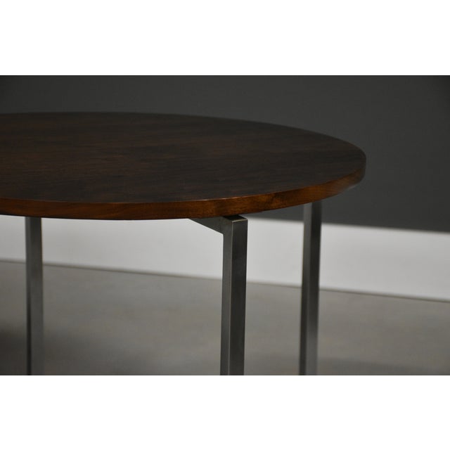 A pair of mid century modern round end tables designed by Florence Knoll with steel legs. Professionally refinished. Circa...