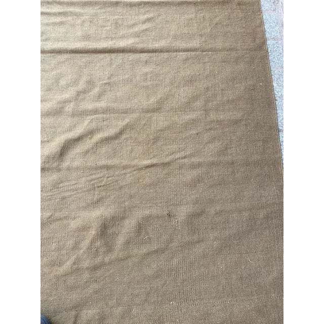 Nice flat rug with a khaki field color, entirely hand woven with cotton on cotton foundation.