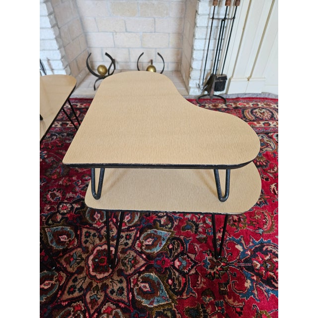 A pair of Mid Century Modern Atomic Side tables with steel tripod hairpin legs. These are authentic two tiered, Mid...