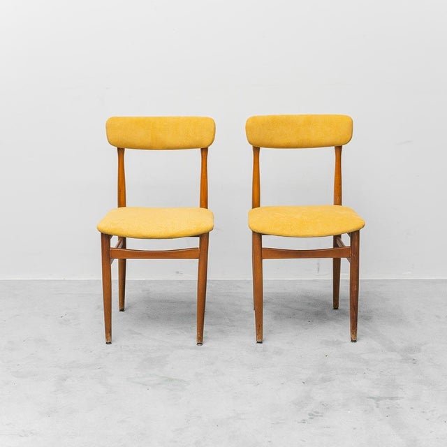 Pair of chairs. Wooden frame and yellow fabric upholstery. The wood shows signs of wear. See photos.