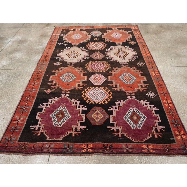 A vintage Turkish Anatolian small room size tribal style carpet handmade during the mid-20th century. Measures: 6' 9" x...