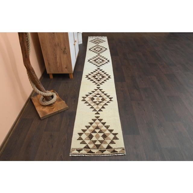 Vintage Turkish Hand-Knotted vintage rug is a semi-antique vintage runner rug. The '70s Eastern region of Turkey's unique...