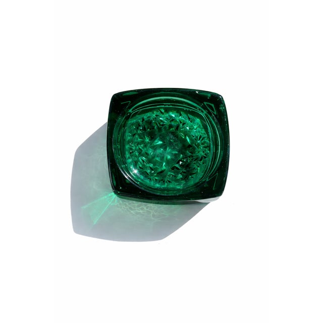 Glass ashtray attributed to Rudolf Jurnikl for Sklo Union, made in Czechoslovakia during the 1960s. Bottle green in color,...