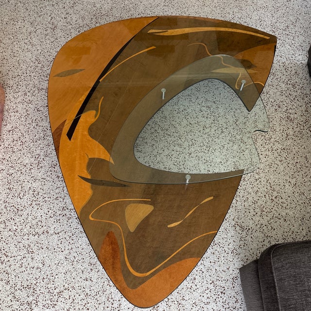 Italian Sculptural masterpiece features floating tempered glass upper level. Various wood grains and veneers arranged then...