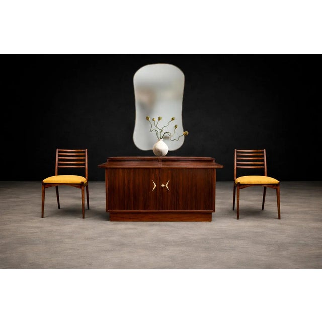 A sculptural Brazilian modernist sideboard or bar crafted in richly figured rosewood and attributed to Ando, Brazil, circa...