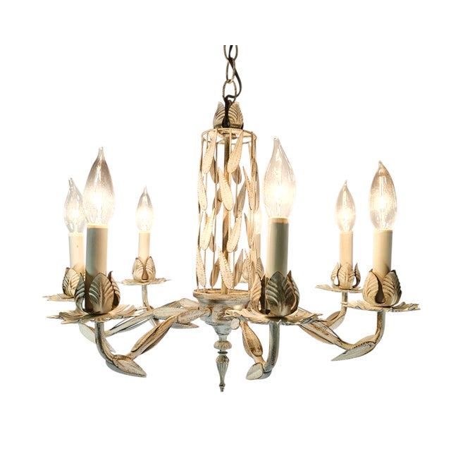 A mid-century Italian tole chandelier with six arms and cascading palm-leaf foliage, hand-formed from painted metal in an...