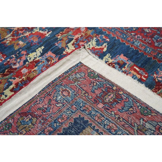 The finely abrashed dark blue ground displays eight off set rows each of four floating rose bouquets in the “Gol-i-Firangi...