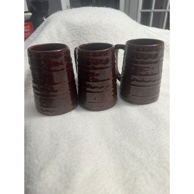 Add a touch of vintage charm to your collection with this elegant set of mugs. Featuring their signature brown glaze and...