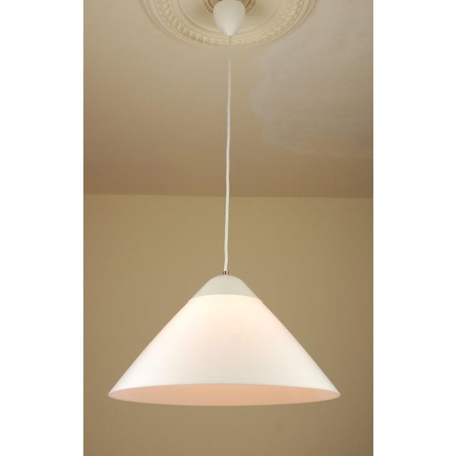 The opala midi pendant lamp, originally designed in 1975 by hans j. Wegner for louis poulsen, is a distinctive example of...