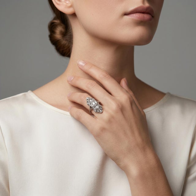 Discover the timeless elegance of our Antique Filigree Diamond Ring, crafted in luxurious platinum and featuring a...