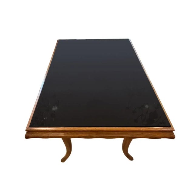 A good sized mid-century occasional table made from fruitwood with a black glass top. Simple elegant design. Made in Italy.