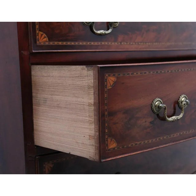 A highly decorative early 19th Century flame mahogany and inlaid bowfront chest of drawers, the figured shaped top above...