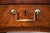 A finely proportioned English Regency period Hepplewhite mahogany serpentine sideboard, with a paneled and elevated...