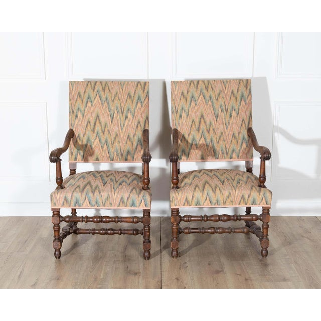 This handsome pair of Louis XIII style armchairs captures the bold character and traditional craftsmanship of 17th-century...