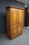 Ethan Allen cherry linen press featuring French Provincial styling, carved serpentine panel doors, decorative crown...