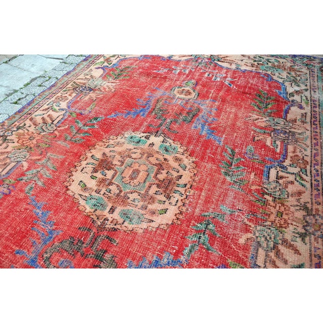 This is a vintage Turkish Oushak rug from the 1960s. The piece was hand-knotted.
