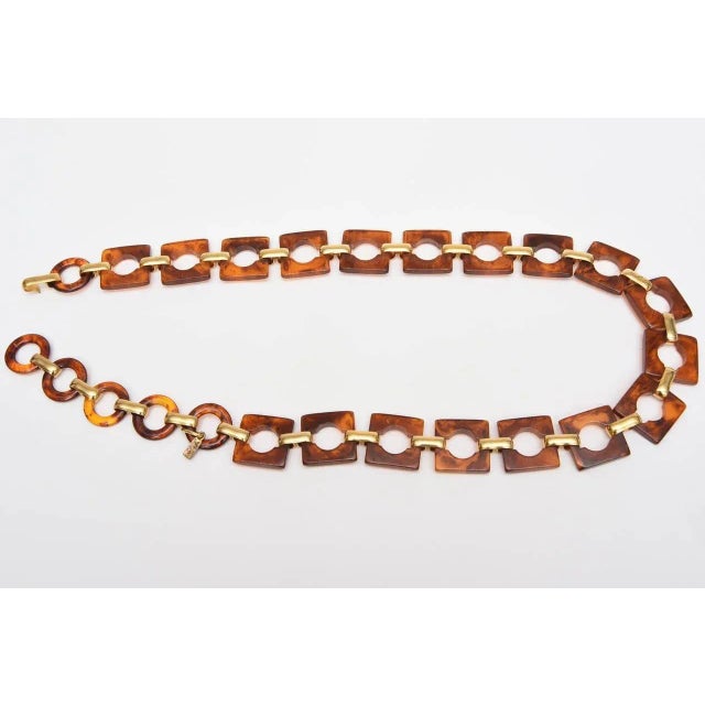 This tagged lovely vintage french waist / hip belt by Yves Saint Laurent is circles and squares of tortoise resin set with...