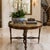 This exquisite round center or foyer table by Maitland-Smith features a stunning inlaid faux marble top adorned with a...