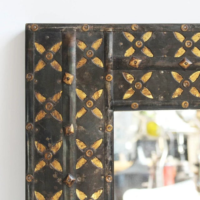 Handsome vintage original Indian ox cart repurposed into a mirror frame. Dark finish iron and hand cut brass pattern...