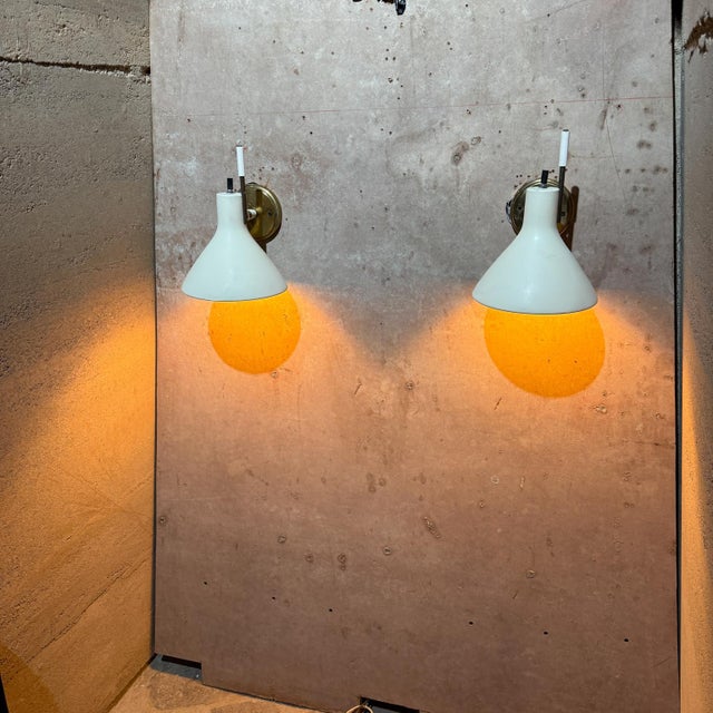 Pair of Lightolier wall scones in offwhite color. Tested and working with out any issues. Brass has original vintage...