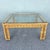 Vintage Boho Chic square coffee table featuring a richly woven natural rattan and wicker frame topped with clear glass....