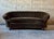 An Antique Curved Chesterfield. Recently recovered in exquisite dark green velvet and featuring a tufted seat back and...