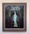 The artwork depicts a serene statue of Hebe, the Greek goddess of youth, standing at the threshold of a lush, vine-covered...