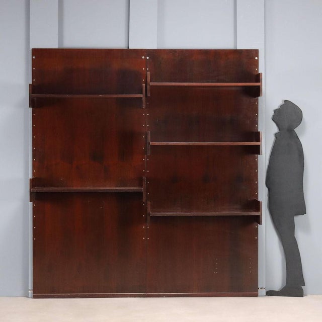 Vintage bookcase featuring adjustable panels and shelves with exotic wood veneer. This piece is attributed to the...