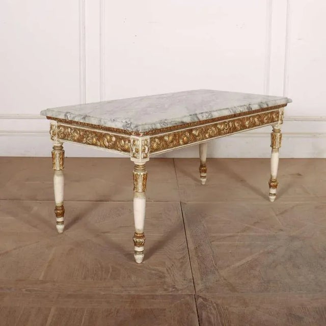1920's French decorated marble topped coffee table. This piece is designed in the style of the selected designer and/or...