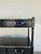 Stylish Jonathan Charles Flux Lacquered Bar / Etagere. 4 drawers with warm silver accents. Glass top. Original Retail...