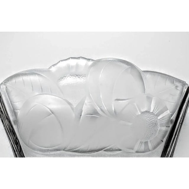 A pair of French Art Deco wall sconces by the French artist " Degue " in good condition in clear and frosted molded glass...