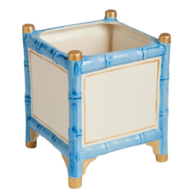 This is a great ceramic cachepot outlined with a bamboo pattern and a touch of gold. Good value and great styling....