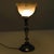 This old table lamp is a magnificent example of the association of brass and molded glass, reflecting a style that is both...