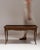 This 20th century Louis XV coffee table in original patina from France is made in dark wood with a lipped top and curved...
