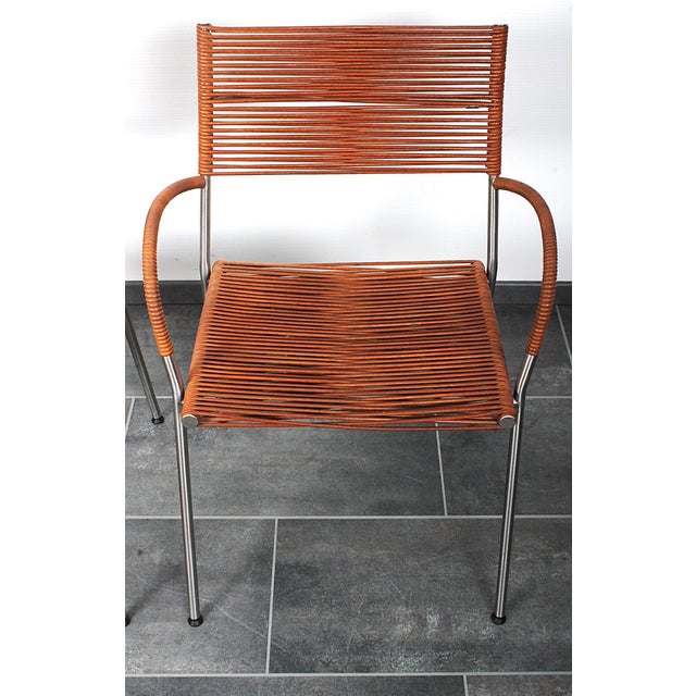 Good comfort and silvergrey lacquered stainless steel frame, with brand mark on the upholstery This piece has an...