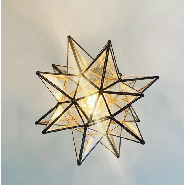 This hand-crafted Moravian star pendant illuminates your home with whimsical sparkle. Oxidized metal finish and clear...
