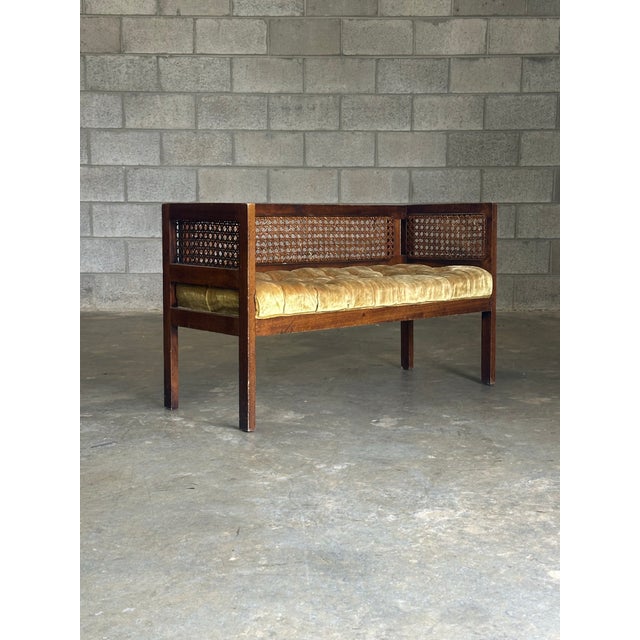 Gorgeous bench with walnut frame and cane inserts. Often attributed to Dunbar furniture. Could blend with many interior...