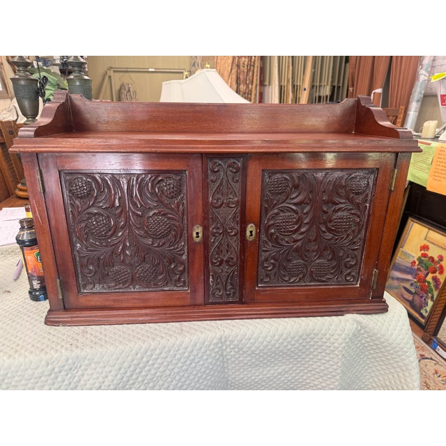 For your consideration is a beautiful Jacobean style hanging cabinet featuring detailed relief carvings, brass keyholes,...