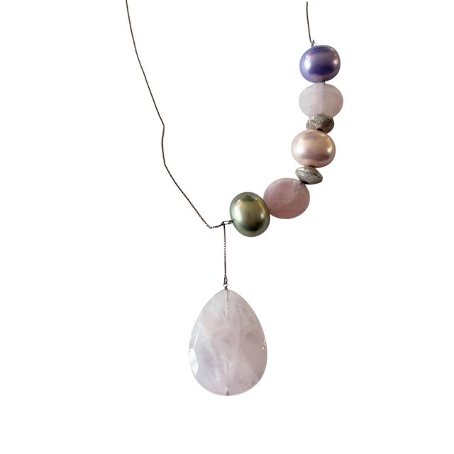 This superb sterling silver necklace showcases a teardrop Brazilian rose quartz pendant in delicate pink, complemented by...