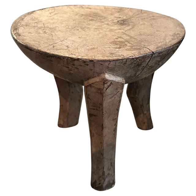 Antique African side table with milky wood tones. Hand carved from a single block of wood. This side table was sourced in...