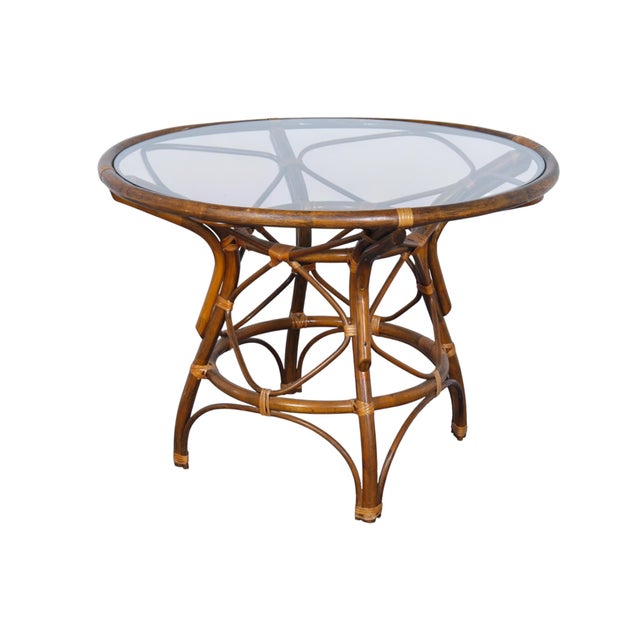 A round bentwood bamboo dining table with a glass top. Bentwood bamboo is supported with pencilwood and secured with...