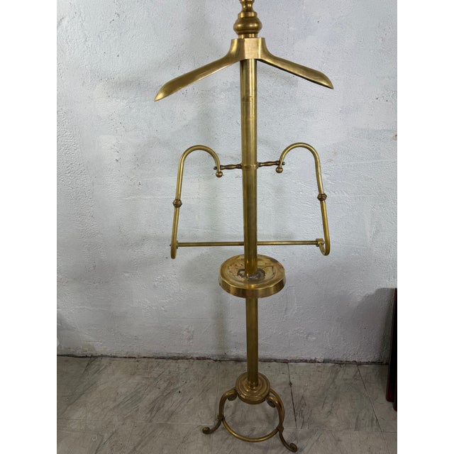 Striking vintage brass gentleman’s valet or store display stand, featuring a sculptural shoulder-form hanger above an...
