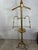 Striking vintage brass gentleman’s valet or store display stand, featuring a sculptural shoulder-form hanger above an...