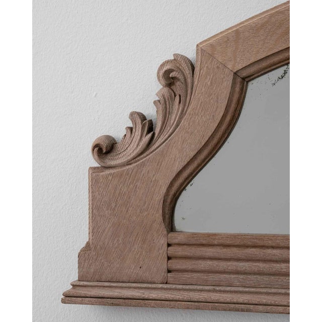 This piece presents as a mirror, distinguished by natural honey wood frame, arched top. It was made in France during...