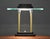 A mid century modern brass and glass desk task table lamp with a black base by Robert Sonneman for George Kovacs. Light...