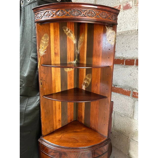 The purpose of this 1940s corner cabinet displays favorite items as well as stores necessities for easy access in...